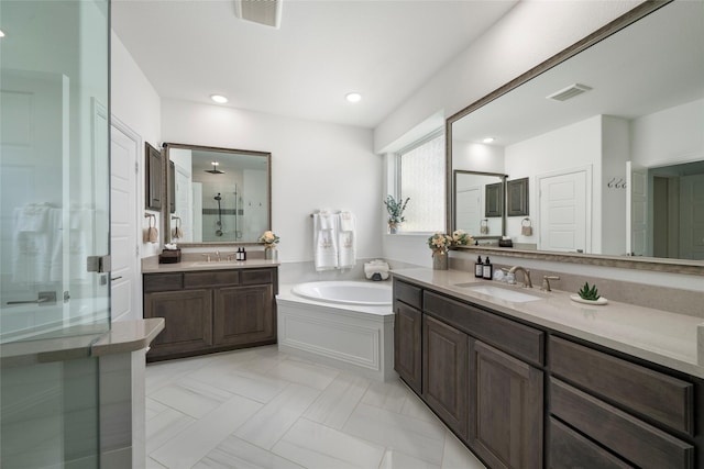 bathroom with vanity and independent shower and bath