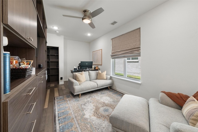 living room featuring wood-type flooring and ceiling fan