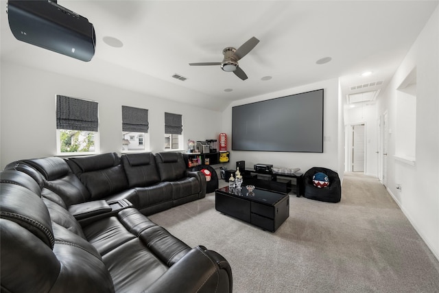 home theater featuring vaulted ceiling, light colored carpet, and ceiling fan