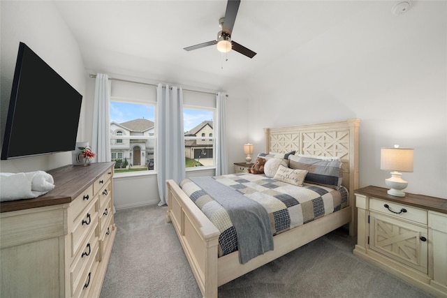 carpeted bedroom featuring vaulted ceiling and ceiling fan