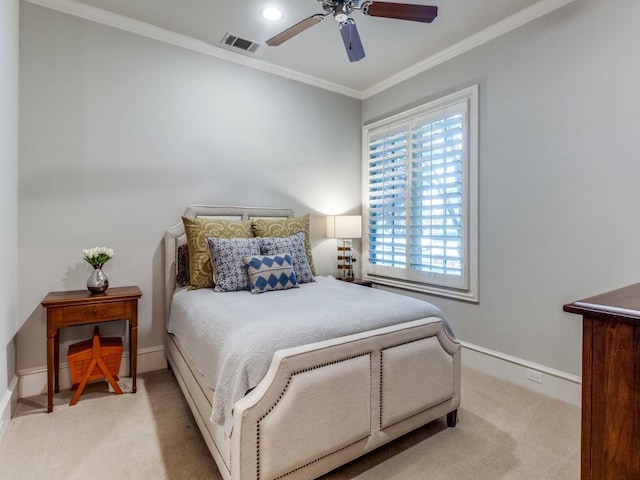 carpeted bedroom with ceiling fan and ornamental molding