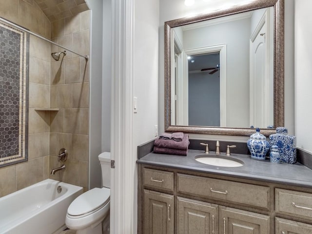 full bathroom with toilet, tiled shower / bath, and vanity