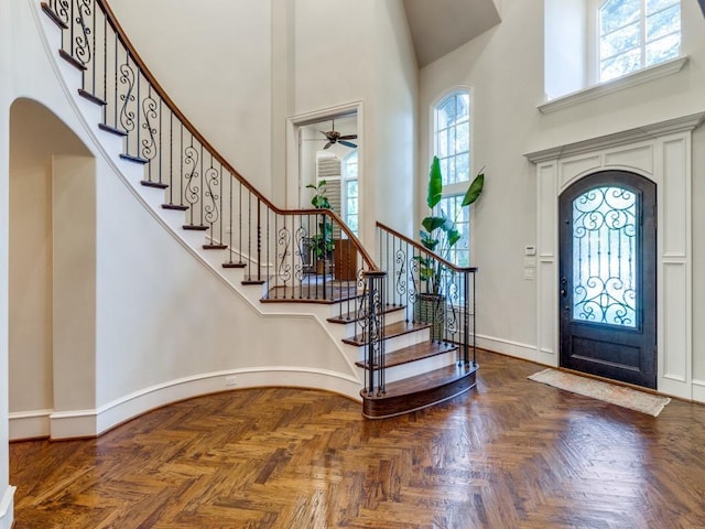 foyer with a high ceiling and parquet flooring