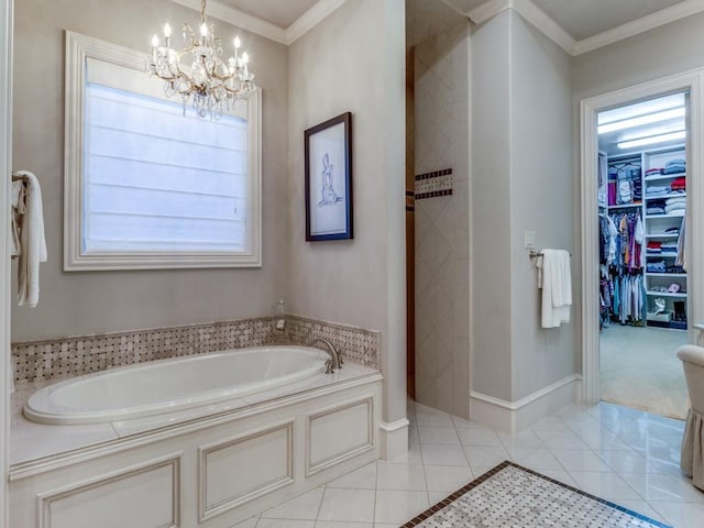 bathroom with a washtub, a wealth of natural light, tile patterned floors, and ornamental molding