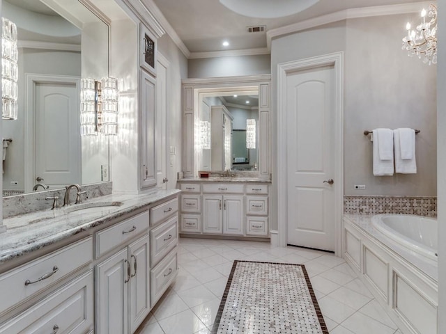 bathroom featuring tile patterned floors, a tub, vanity, a notable chandelier, and ornamental molding