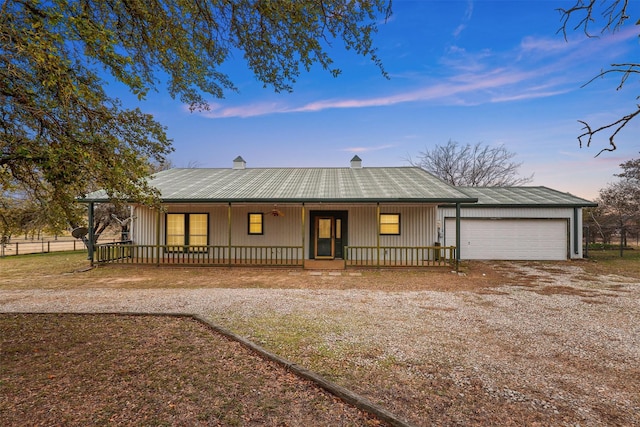 ranch-style home with a porch and a garage