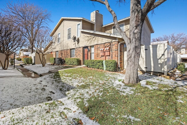 exterior space with central AC and a yard