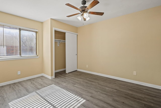 unfurnished bedroom with a closet, ceiling fan, and hardwood / wood-style floors