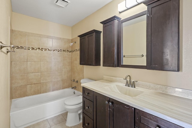 full bathroom featuring vanity, toilet, tile patterned floors, and tiled shower / bath