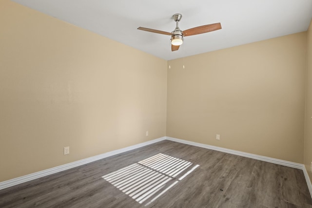 unfurnished room featuring ceiling fan and dark wood-type flooring