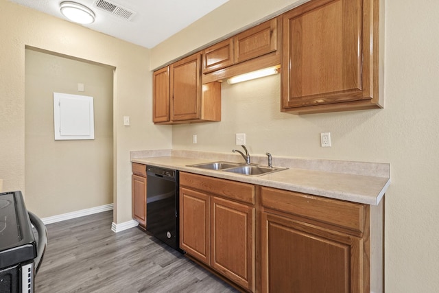 kitchen with sink, light hardwood / wood-style floors, electric range, and dishwasher