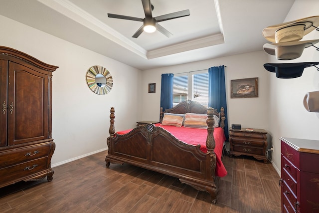 bedroom featuring baseboards, a raised ceiling, a ceiling fan, dark wood finished floors, and ornamental molding