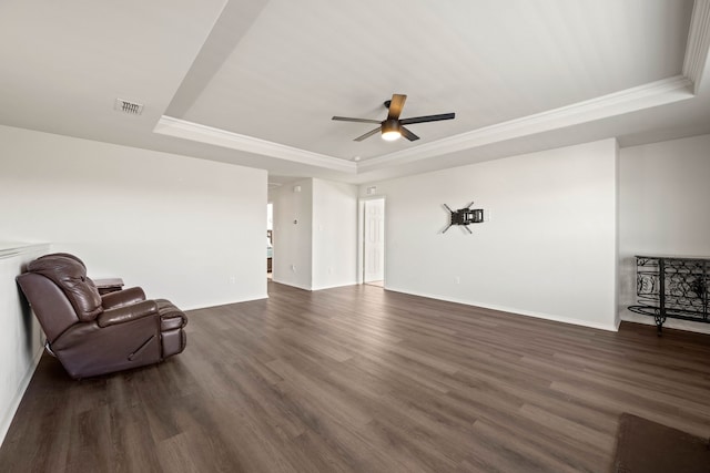 sitting room featuring visible vents, crown molding, a tray ceiling, and dark wood-type flooring