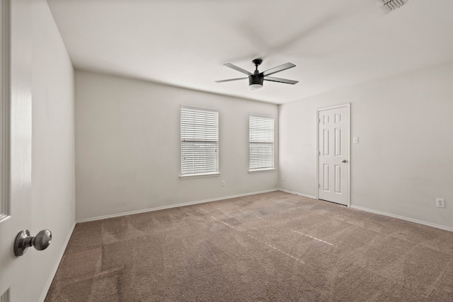 empty room with ceiling fan, baseboards, and carpet flooring