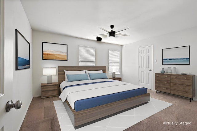 bedroom featuring a ceiling fan, light carpet, and baseboards