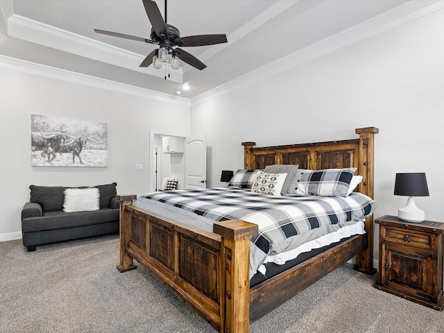 carpeted bedroom featuring a tray ceiling, ceiling fan, and ornamental molding