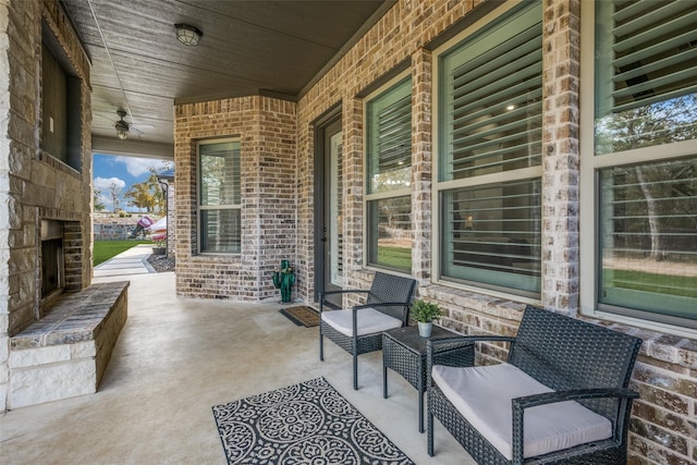 view of patio / terrace featuring an outdoor stone fireplace