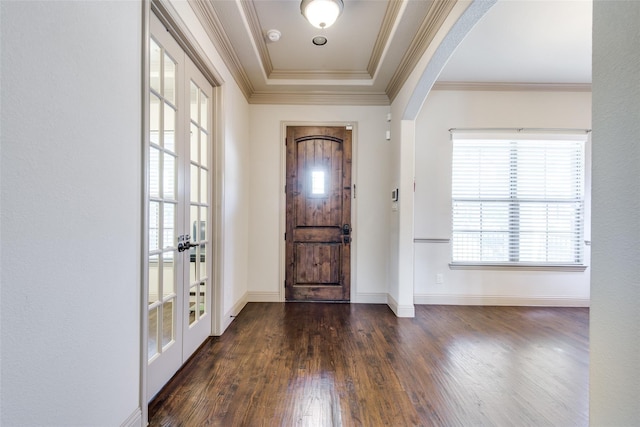 entryway featuring a tray ceiling, dark hardwood / wood-style floors, ornamental molding, and french doors