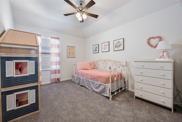 bedroom with ceiling fan, dark colored carpet, and vaulted ceiling