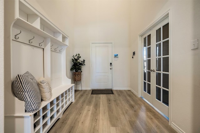 mudroom with french doors and wood-type flooring