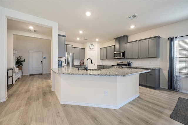 kitchen with sink, gray cabinetry, stainless steel appliances, and light wood-type flooring