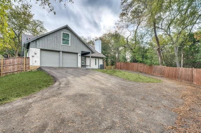 exterior space with a garage and central AC