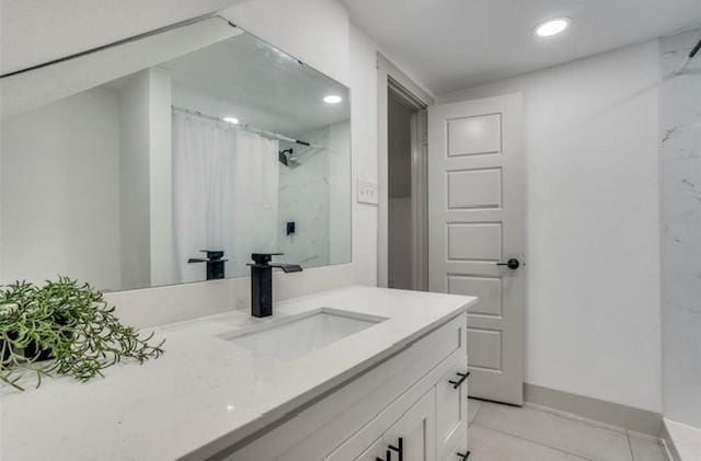 bathroom featuring vanity, curtained shower, and tile patterned floors