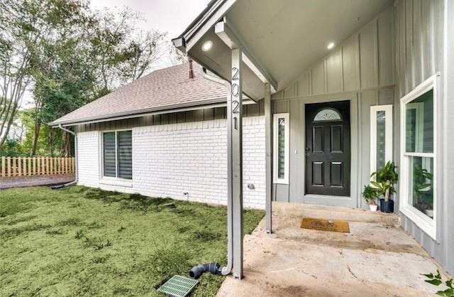 doorway to property featuring a yard