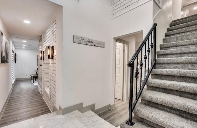 stairs featuring wood-type flooring