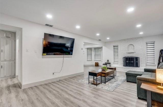 living room featuring light hardwood / wood-style floors and a fireplace