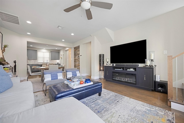 living room with ceiling fan and dark hardwood / wood-style floors