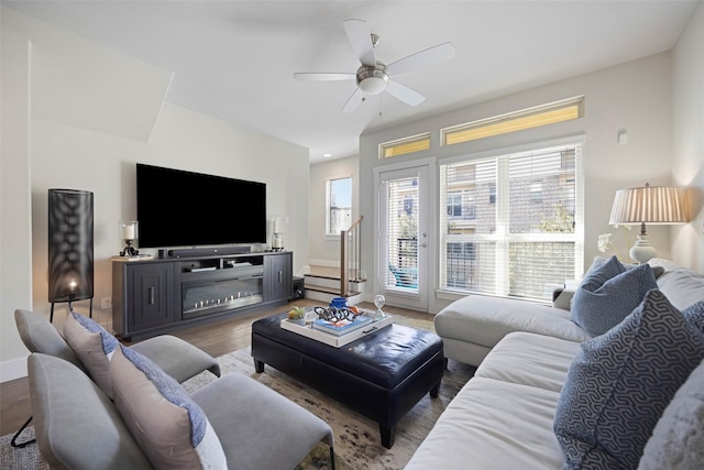 living room featuring hardwood / wood-style floors and ceiling fan