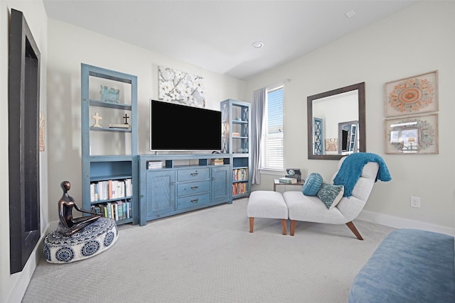 sitting room featuring light colored carpet