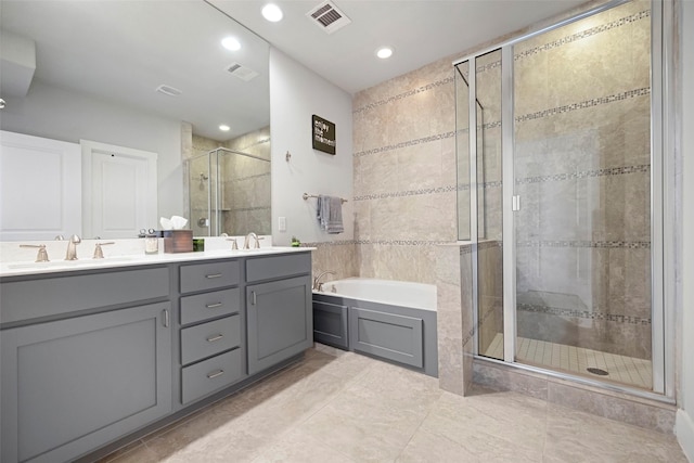 bathroom featuring vanity, shower with separate bathtub, and tile patterned floors