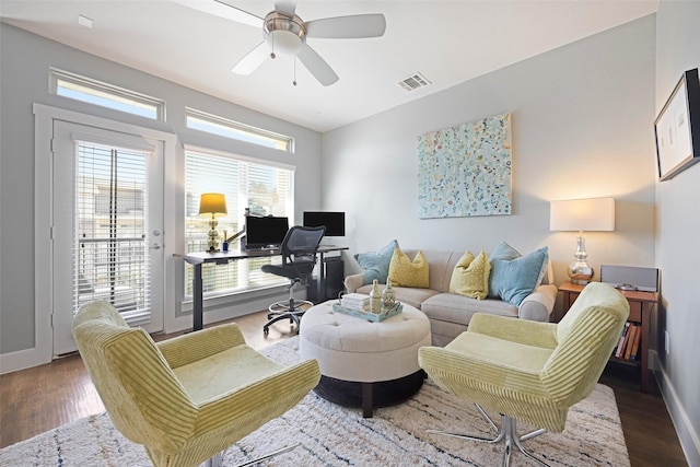 living room with a healthy amount of sunlight, dark hardwood / wood-style floors, and ceiling fan