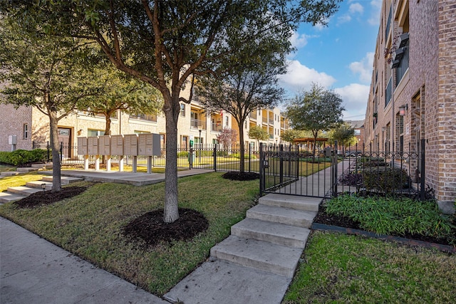 surrounding community featuring mail boxes and a yard