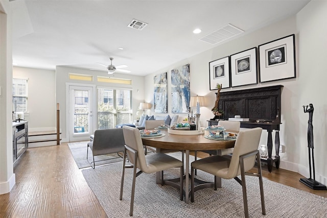 dining space featuring ceiling fan and light wood-type flooring