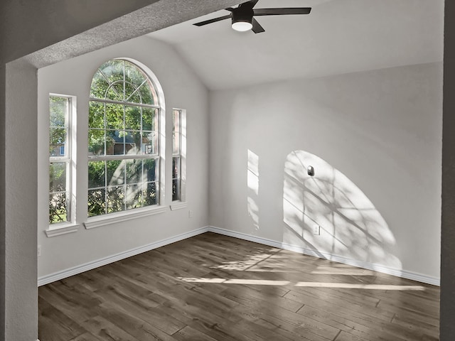 empty room featuring ceiling fan, dark hardwood / wood-style floors, and lofted ceiling