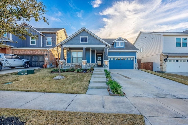 craftsman inspired home with a porch, a garage, and a front lawn