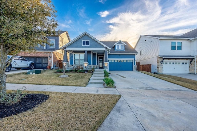 craftsman house with a garage, a front yard, and a porch