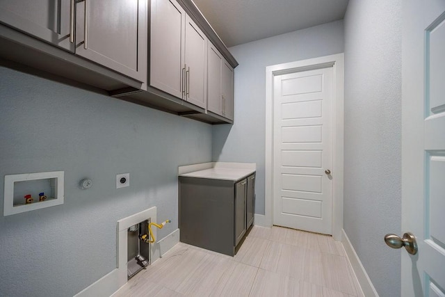 washroom with gas dryer hookup, electric dryer hookup, cabinets, and hookup for a washing machine