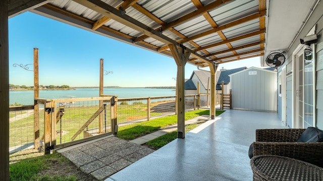 view of patio featuring a water view and an outdoor structure