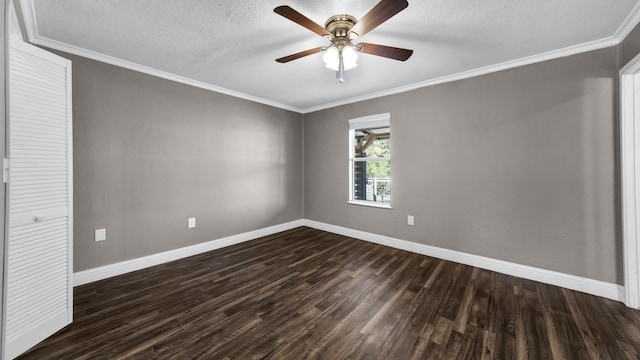 empty room featuring a textured ceiling, ornamental molding, and dark hardwood / wood-style floors