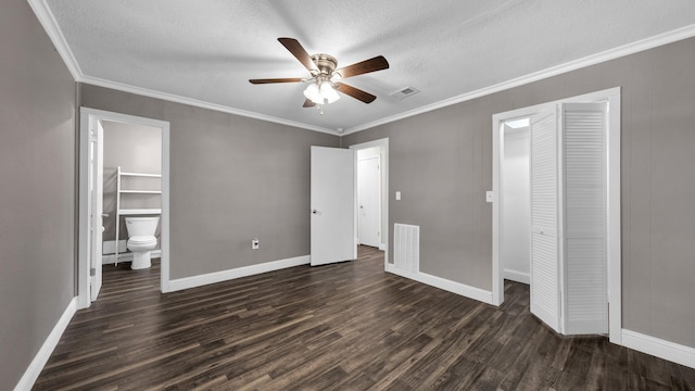 unfurnished bedroom with dark hardwood / wood-style flooring, ensuite bath, crown molding, and a textured ceiling