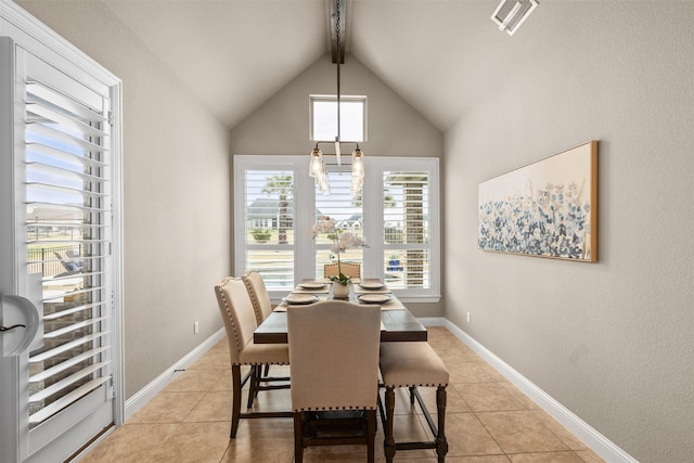 dining space with lofted ceiling with beams and light tile patterned flooring