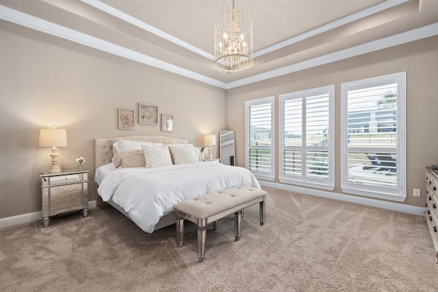 carpeted bedroom with a tray ceiling, ornamental molding, an inviting chandelier, and multiple windows