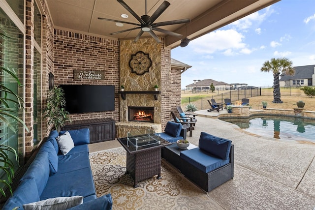 view of patio / terrace featuring a fenced in pool and an outdoor living space with a fireplace