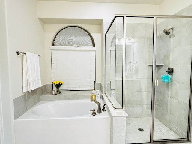 bathroom with shower with separate bathtub