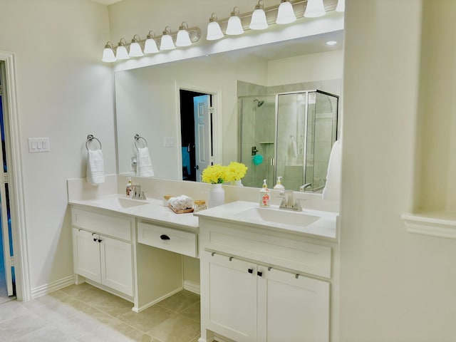 bathroom with vanity, a shower with shower door, and tile patterned floors