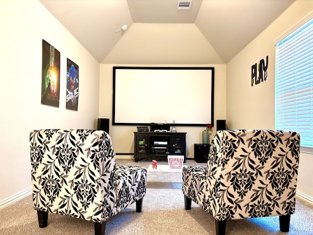 cinema with lofted ceiling and carpet